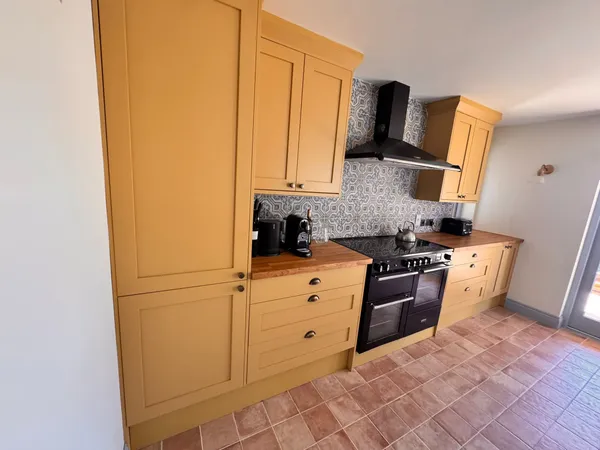 Renovated kitchen with contemporary cabinetry and hardwood flooring completed by Big Sky Construction, Norfolk
