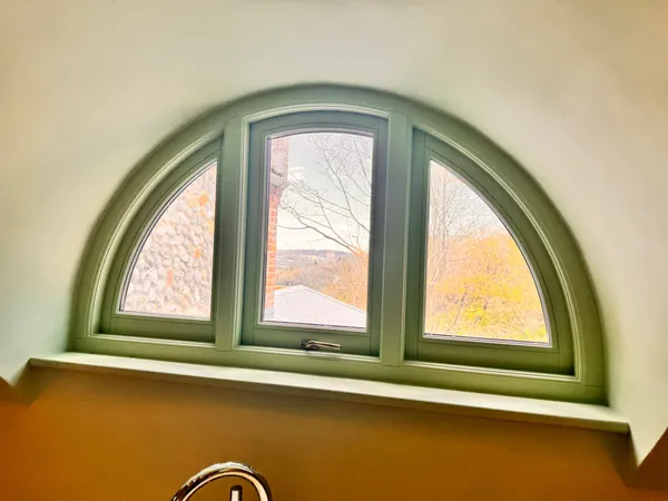 Bespoke circular window feature installation  -  unique architectural joinery detail completed by Big Sky Construction, Norfolk