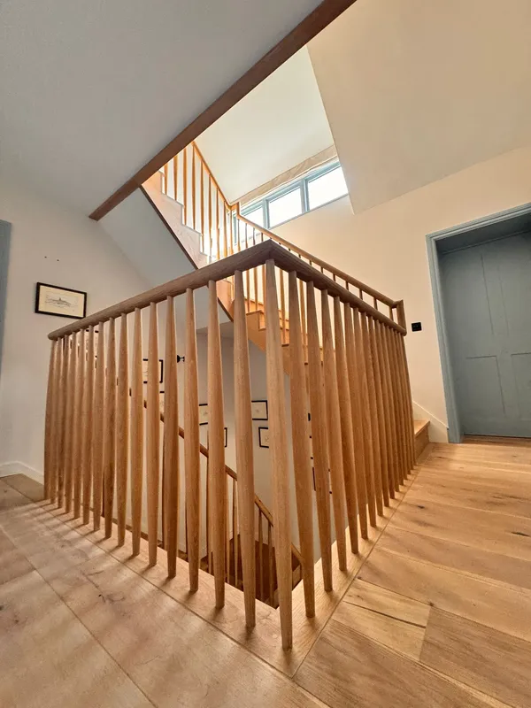 Bespoke stairwell banister and timber handrail joinery crafted and installed by Big Sky Construction, Wymondham, Norfolk